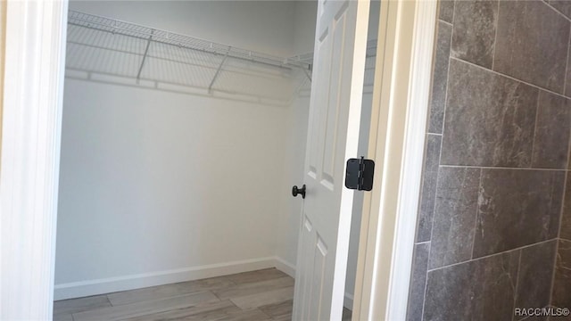 walk in closet featuring hardwood / wood-style floors