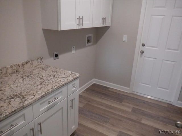 washroom featuring cabinets, hookup for an electric dryer, hardwood / wood-style flooring, and washer hookup