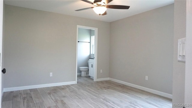 unfurnished bedroom with ensuite bathroom, ceiling fan, and light hardwood / wood-style floors