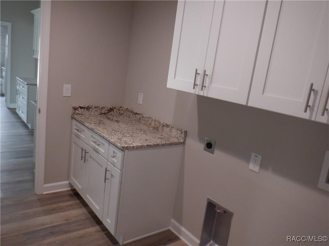 laundry room with cabinets, dark hardwood / wood-style floors, and electric dryer hookup