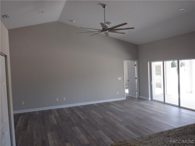 spare room featuring vaulted ceiling, dark hardwood / wood-style floors, and ceiling fan