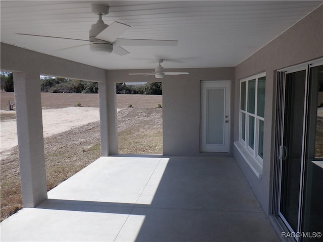 view of patio featuring ceiling fan