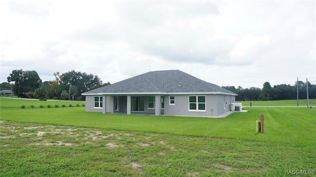 rear view of house with a yard