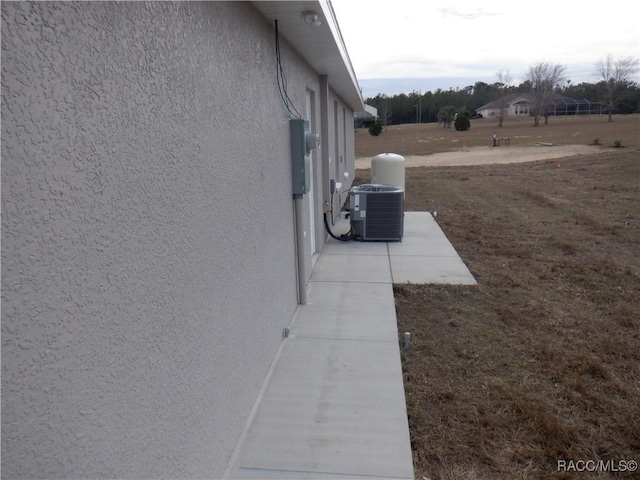 view of side of home with central air condition unit