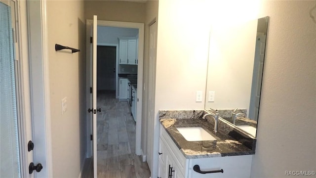 bathroom featuring vanity and wood-type flooring