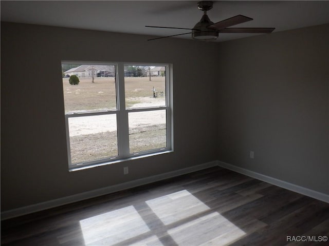 unfurnished room featuring a healthy amount of sunlight, hardwood / wood-style floors, and ceiling fan