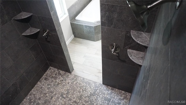 bathroom with a tile shower