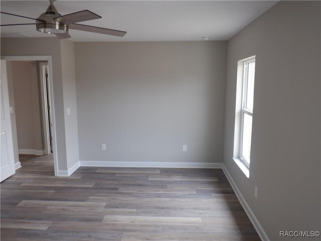 empty room with hardwood / wood-style floors and ceiling fan