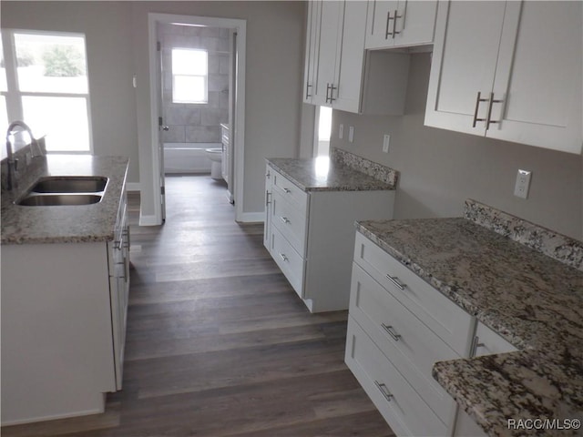 kitchen featuring sink, dark hardwood / wood-style floors, and white cabinets