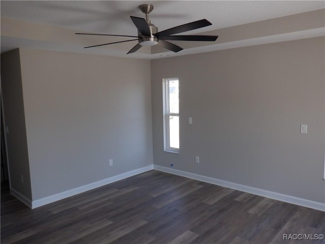 unfurnished room with ceiling fan and dark hardwood / wood-style flooring