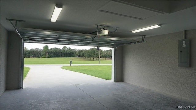 garage featuring electric panel and a yard