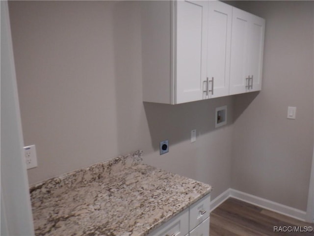 laundry room with washer hookup, electric dryer hookup, dark hardwood / wood-style flooring, and cabinets