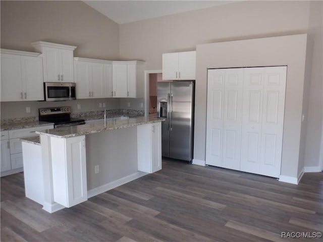 kitchen with a kitchen island, white cabinetry, and appliances with stainless steel finishes