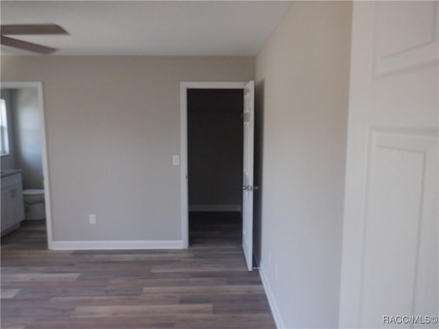 unfurnished bedroom featuring dark hardwood / wood-style flooring and ensuite bathroom