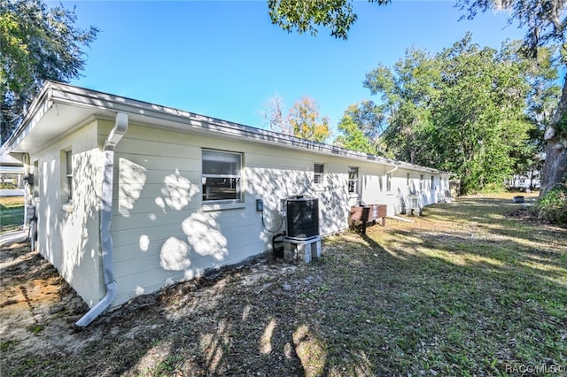 view of home's exterior with a yard and cooling unit