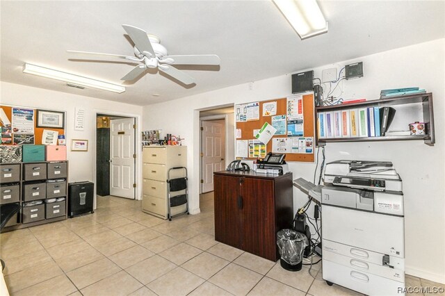 tiled home office featuring ceiling fan