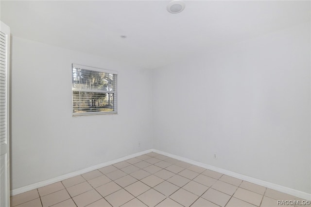 unfurnished room with light tile patterned floors