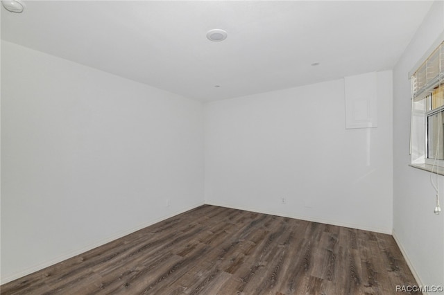 unfurnished room featuring dark hardwood / wood-style floors