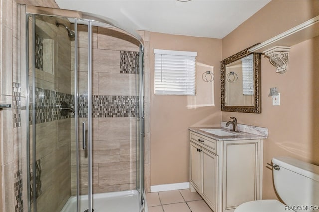 bathroom with tile patterned floors, toilet, an enclosed shower, and vanity