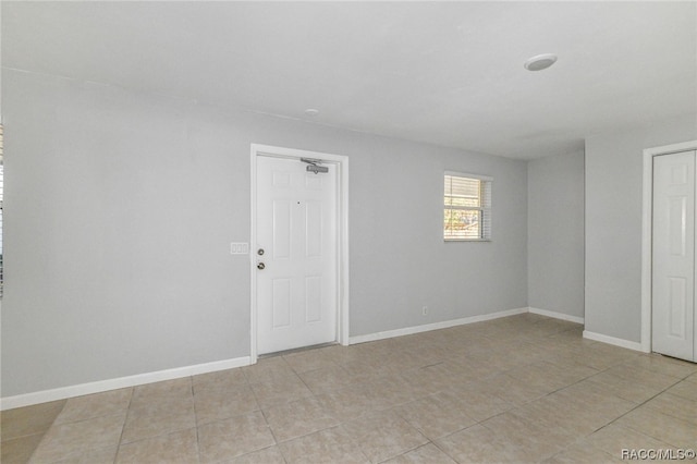 spare room featuring light tile patterned floors