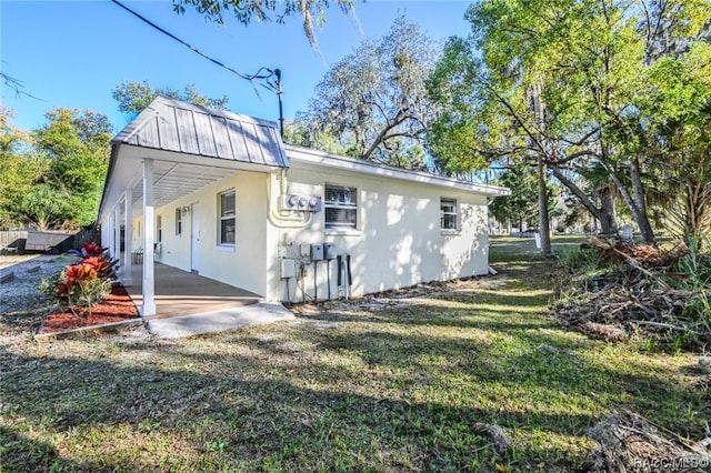 rear view of house featuring a yard