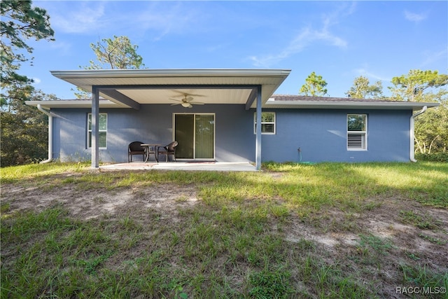 back of property with ceiling fan and a patio