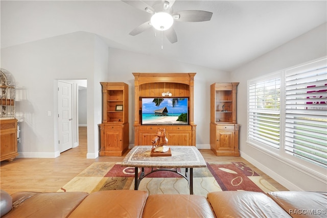 living room with light wood-type flooring, ceiling fan, and lofted ceiling