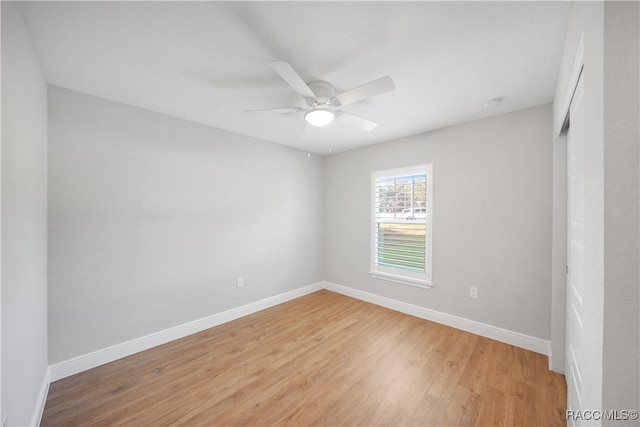 spare room featuring light hardwood / wood-style flooring and ceiling fan