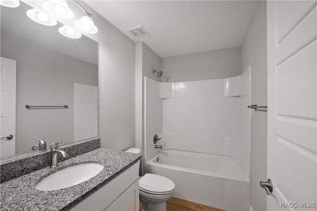 full bathroom with shower / bathtub combination, vanity, a textured ceiling, wood-type flooring, and toilet