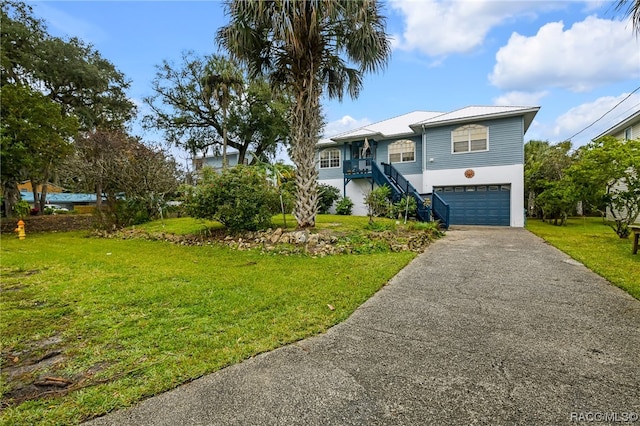 view of front of home featuring a garage and a front lawn