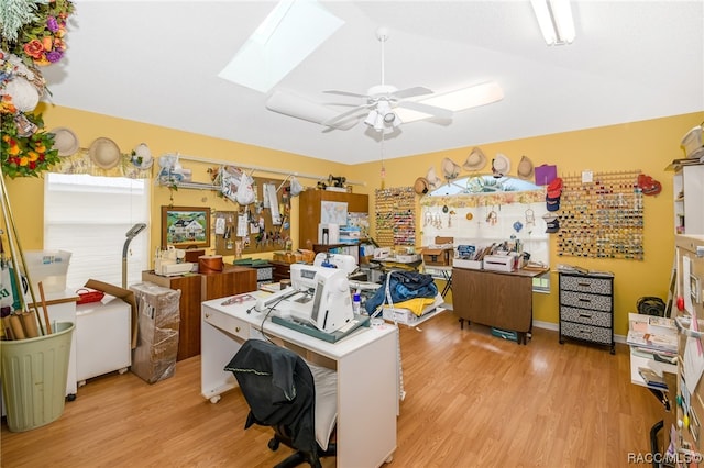 office area with light hardwood / wood-style floors, a skylight, and ceiling fan