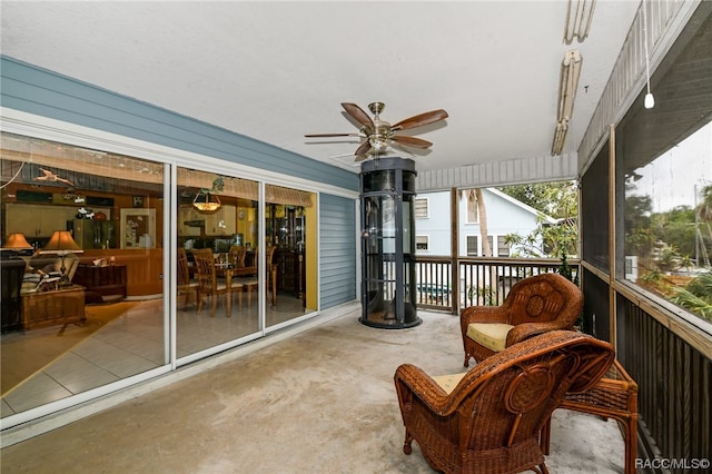 sunroom / solarium featuring ceiling fan