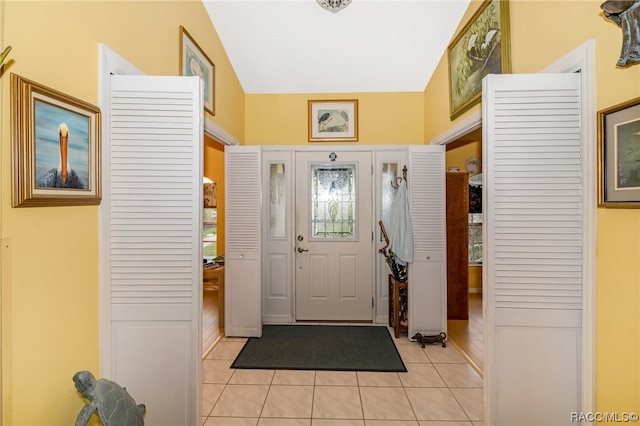 tiled entrance foyer featuring lofted ceiling