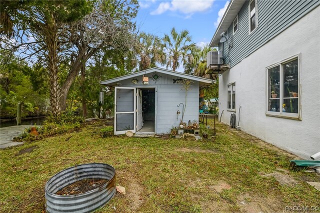 view of yard with an outdoor structure and central AC