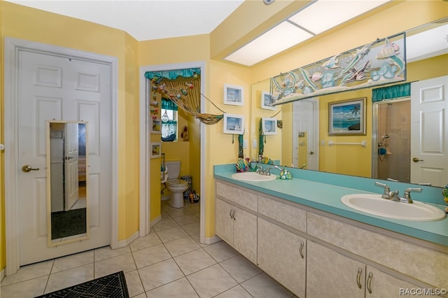 bathroom featuring toilet, vanity, tile patterned floors, and walk in shower