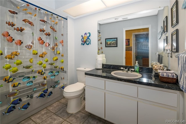 full bathroom with tile patterned flooring, shower / bath combo, vanity, and toilet