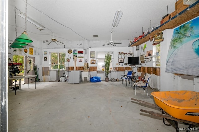 misc room featuring concrete floors and ceiling fan