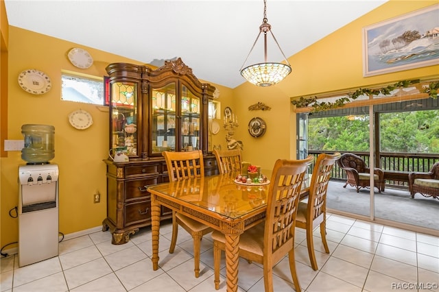 tiled dining room with lofted ceiling