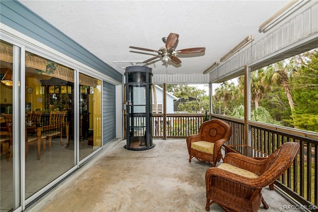 sunroom / solarium featuring ceiling fan