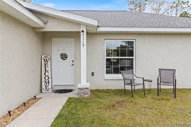 property entrance featuring a yard