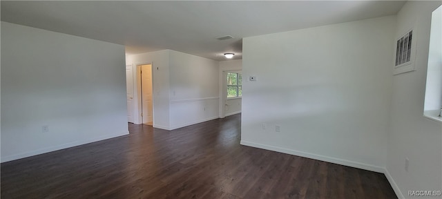 spare room featuring dark wood-type flooring