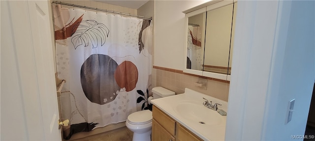 bathroom featuring walk in shower, tile patterned floors, toilet, vanity, and tile walls