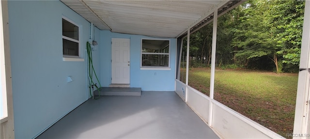 unfurnished sunroom with lofted ceiling