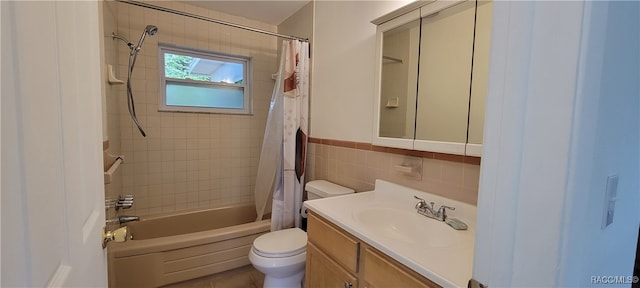 full bathroom with shower / bathtub combination with curtain, vanity, tile walls, and toilet