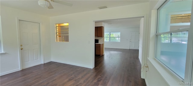 empty room featuring ceiling fan and dark wood-type flooring