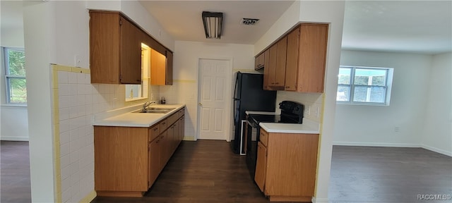 kitchen featuring plenty of natural light, dark hardwood / wood-style floors, and black / electric stove