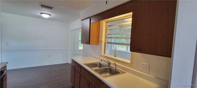 kitchen with backsplash, dark hardwood / wood-style floors, and sink