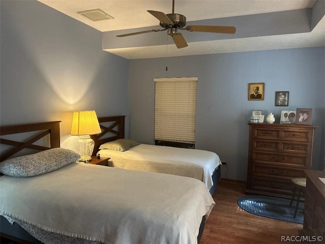 bedroom featuring dark hardwood / wood-style floors and ceiling fan