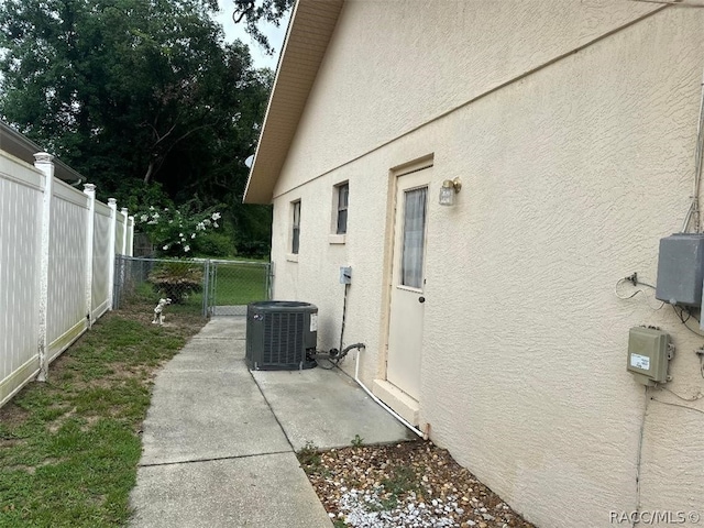 view of side of home with central AC unit