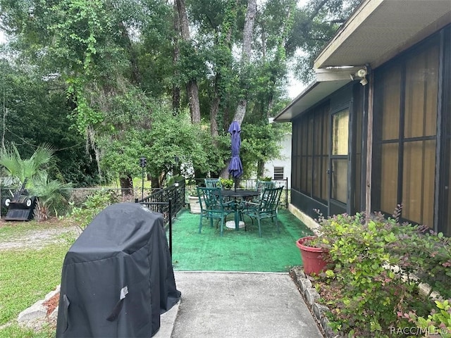 view of patio / terrace featuring grilling area and a sunroom